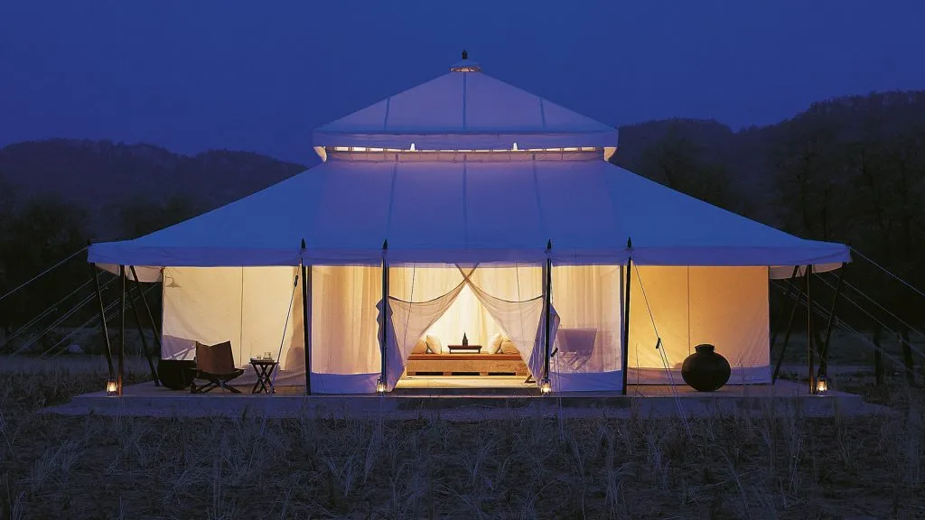 Glamping tent glowing softly at night