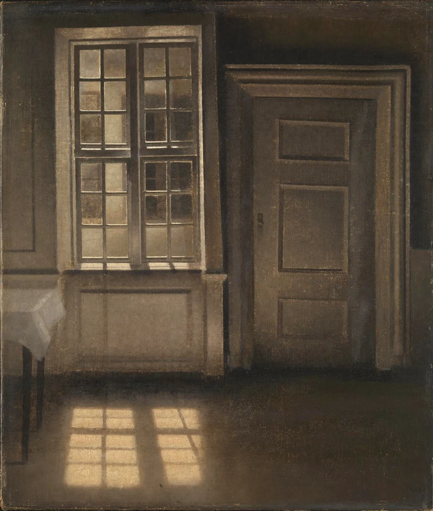 A quiet, sunlit room with closed doors and bare wooden floors, evoking stillness, solitude, and the introspective hush of absence.