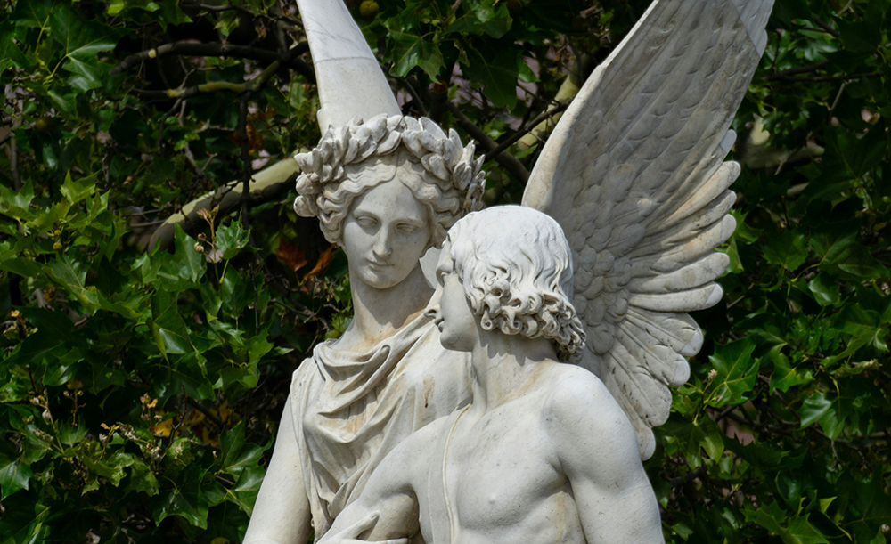 Marble statue of the winged goddess Nike tenderly supporting a wounded warrior. Sculpture by Ludwig Wilhelm Wichmann.